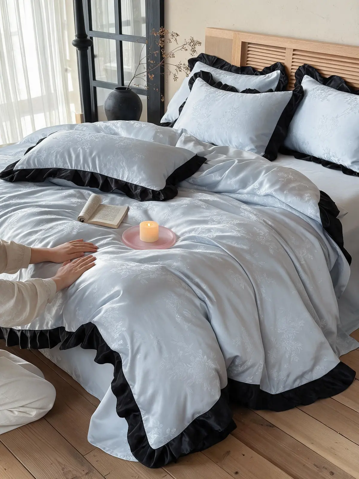 Quilt set with coral and navy medallion pattern laid over a neutral duvet on a sunlit bed
