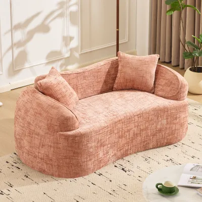 Pink curved two - person compress sofa. It has armrests on both sides, comes with two pillows, is suitable for small - sized apartments, and can be placed in the living room or bedroom.